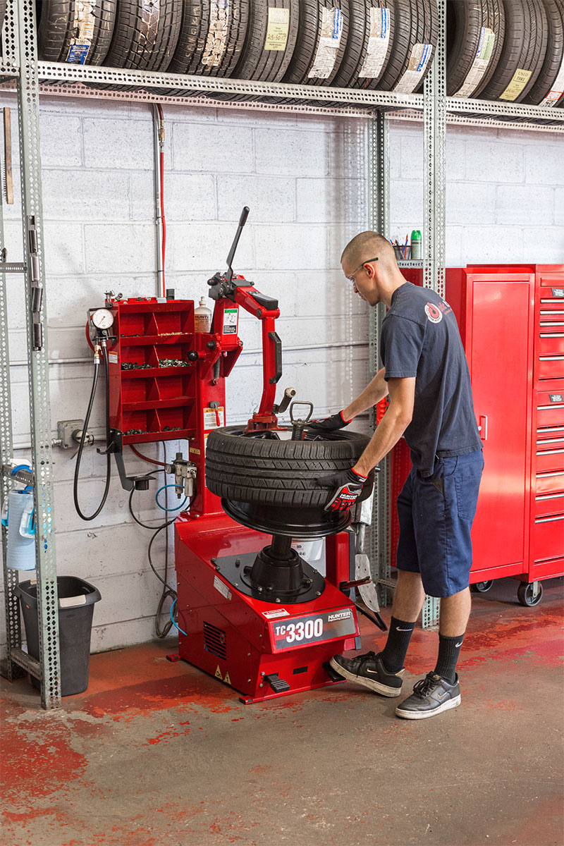 technician changing tire on tc3300 tire changer