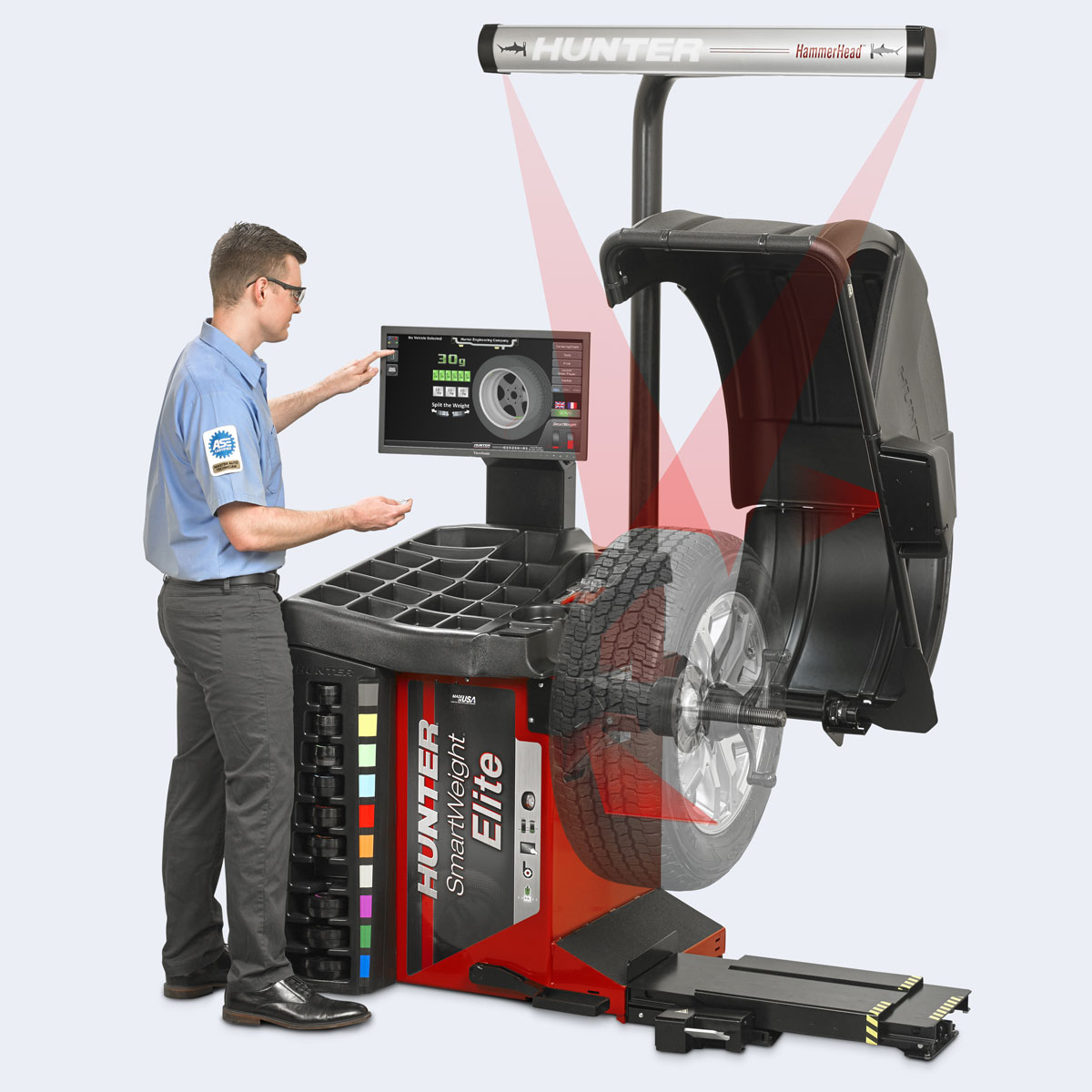 technician operating hunter smartweight elite wheel balancer